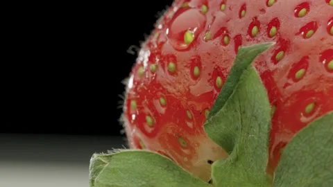 A drop drips on a ripe strawberry Stock Footage 150976607