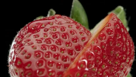 A drop drips on a ripe strawberry Stock Footage 150976644