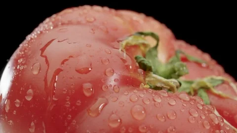 A drop drips on a ripe tomato Stock Footage 150909175