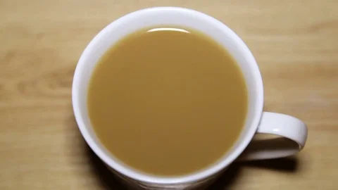 Drop a drop of cappuccino into a cup Stock Footage 81199418