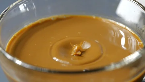 Drop of espresso falls into the filled Cup from the coffee machine Stock Footage 113595607