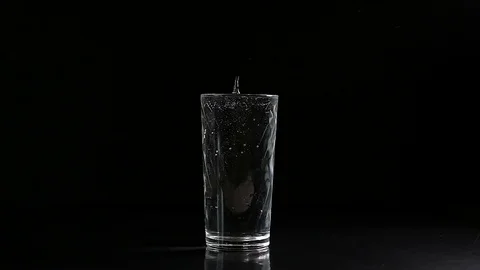 Drop falling into a glass of water Stock Footage 74343638
