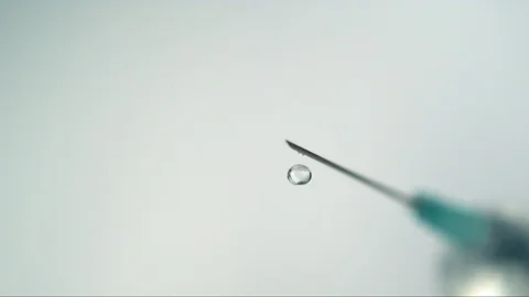 Drop falling from the needle of syringe in slow motion / high speed camera 스톡 동영상 101016185