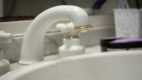 Drop falling from a sink faucet. In slow motion Stock Footage 282550178