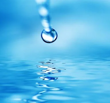 Drop falling in water Stock Photos