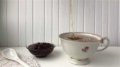 Drop falls in a cup of tea Видео 82693058