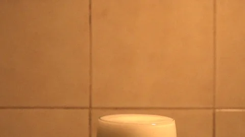 Drop that falls into the full glass in super slow motion Stock Footage 102236822