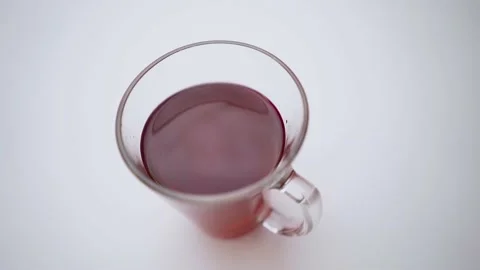 A drop falls from a mug of drink. Close-up of a transparent teapot with brown Stock Footage 166695784