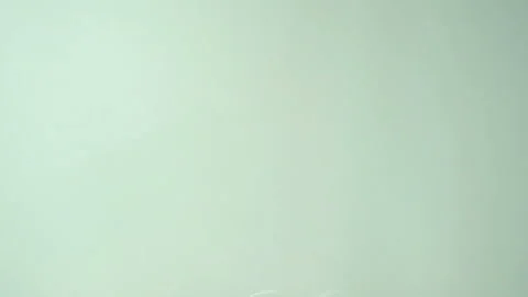 A drop falls in slow motion to the surface of the milk. Stock Footage 130520387