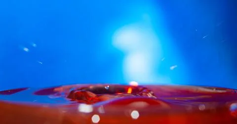 A drop falls on the surface of the water . Stock Photos