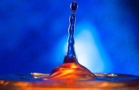 A drop falls on the surface of the water . Stock Photos