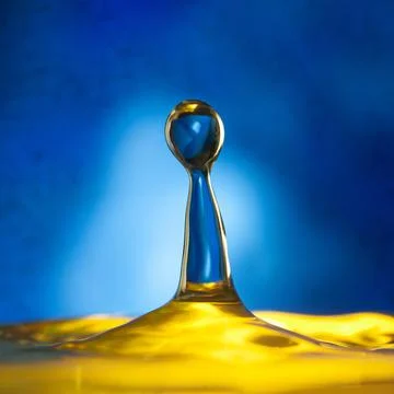 A drop falls on the surface of the water Stock Photos