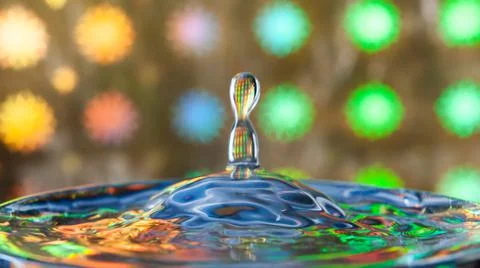 A drop falls on the surface of the water . Stock Photos