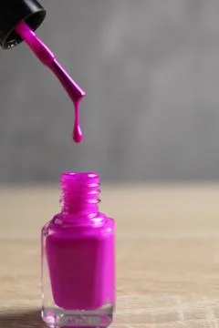 The drop flows down with lilac nail polish brushes. Manicure how to choose a Stock Photos