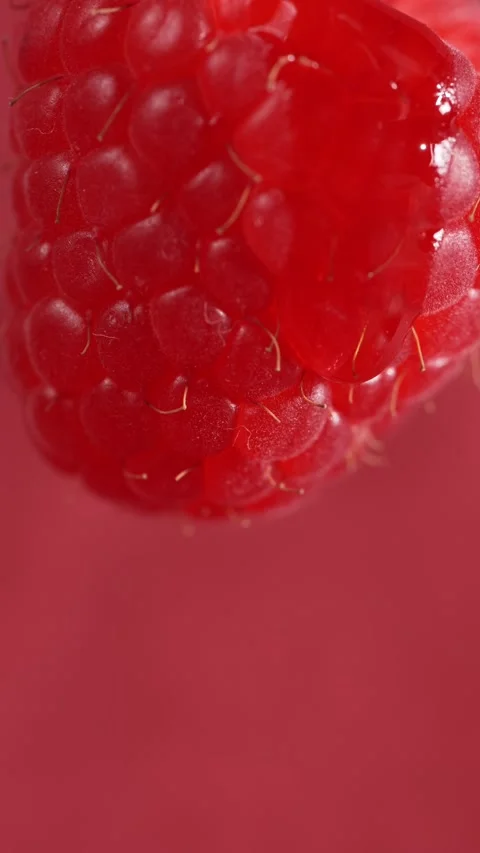 A drop flows down a raspberry berry, macro Stock Footage 313611081