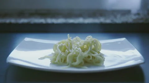 Drop fresh spaghetti on a plate slow motion Stock Footage 57639079