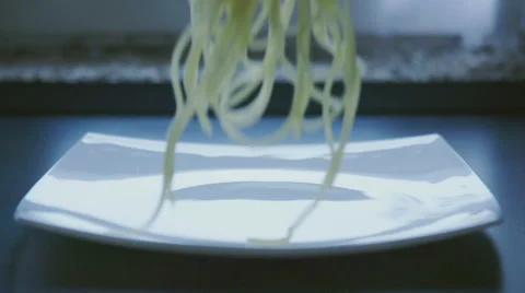 Drop fresh spaghetti on a plate slow motion Stock Footage 57639088