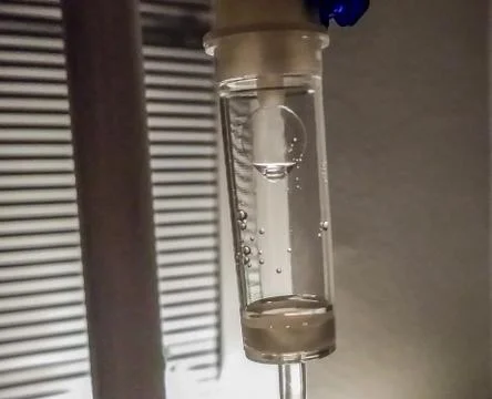 Drop hanging in the flow Stock Photos