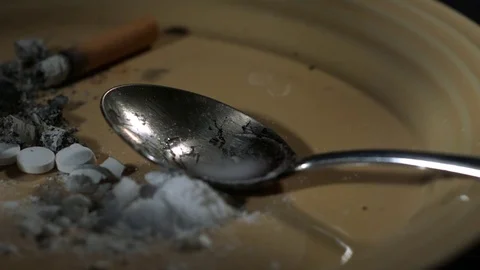 Drop of heroin falling into the plate Stock Footage 81230360