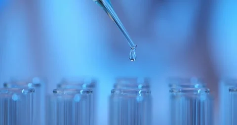 Drop of liquid from glass pipette into test tube in laboratory Vídeos de archivo 280992012