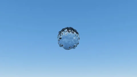 A drop of liquid rotates slowly and breaks up into many splashes on a blue Stockbeeldmateriaal 127270945