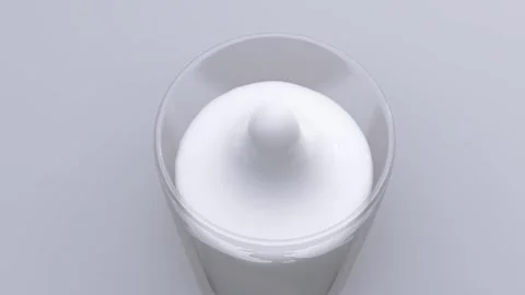 Drop of milk falls in an already full glass Stock Footage 143865468