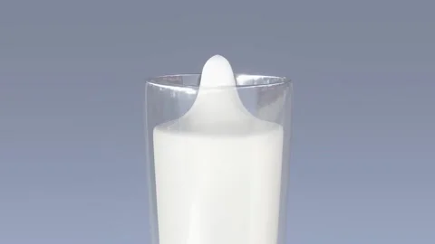 Drop of milk falls into an already full glass Stock Footage 143865559