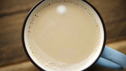 Drop of milk falls into full cup of coffee Stock-Footage 106146743