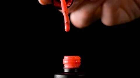 A drop of nail polish drips into an open bottle, Slow drop drops of nail gel Stock Footage 128749769