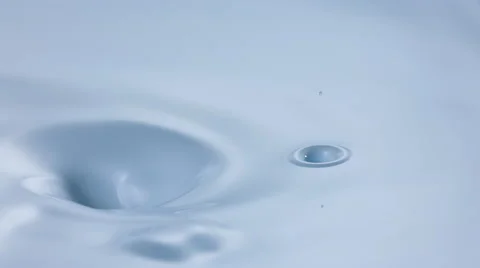 A drop of oil falling into cream swirl. Slow Motion. Stock Footage