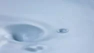 A Drop Of Oil Falling Into Cream Swirl. Slow Motion. Stock Footage