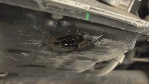 Drop of oil falling under the car 6 Stock Footage 153743855