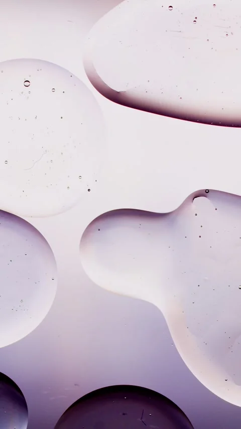 A drop of oil on a white background absorbs another drop 動画素材 237706713