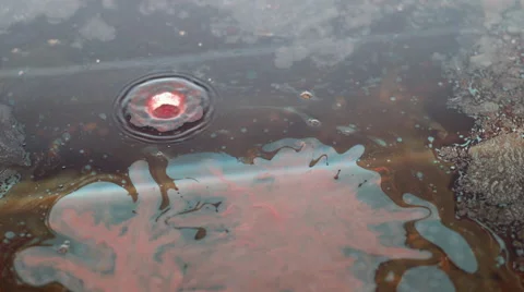 Drop of orange oil paint falling in water Stock Footage 46667023