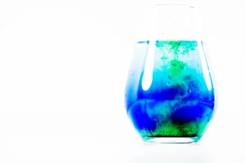 A drop of paint in a jar of water Stock Photos