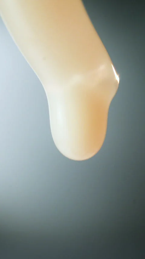 Drop of pearly viscous liquid falling on a gradient background Stock Footage 340282844