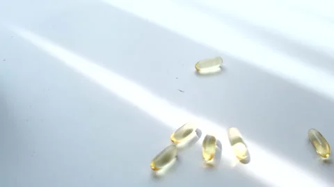 Drop pills on white table Stock Footage 204710098