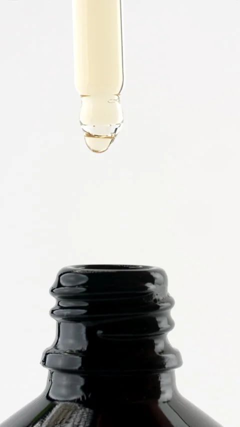 Drop from pipette above open bottle Stock Footage 311025337
