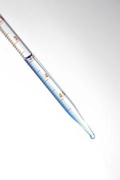 Drop from pipette Stock Photos