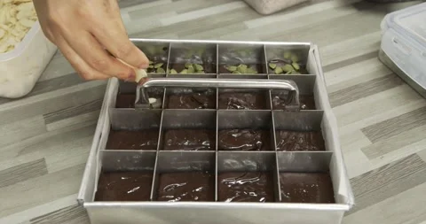 Drop raw materials watermelon seeds into brownies before baking in the oven. Stock Footage 154857369