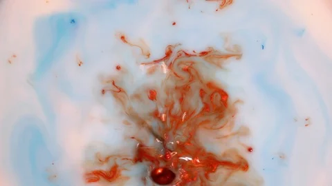 Drop of Red Orange Paint into a White Blue Liquid 스톡 동영상 123735404