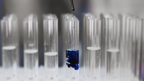 Drop of sample of blue liquid into a test tube in the laboratory. Stock Footage 302172642