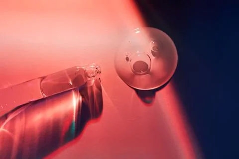 A drop of serum for the face on the border of light and shadow. Stock Photos