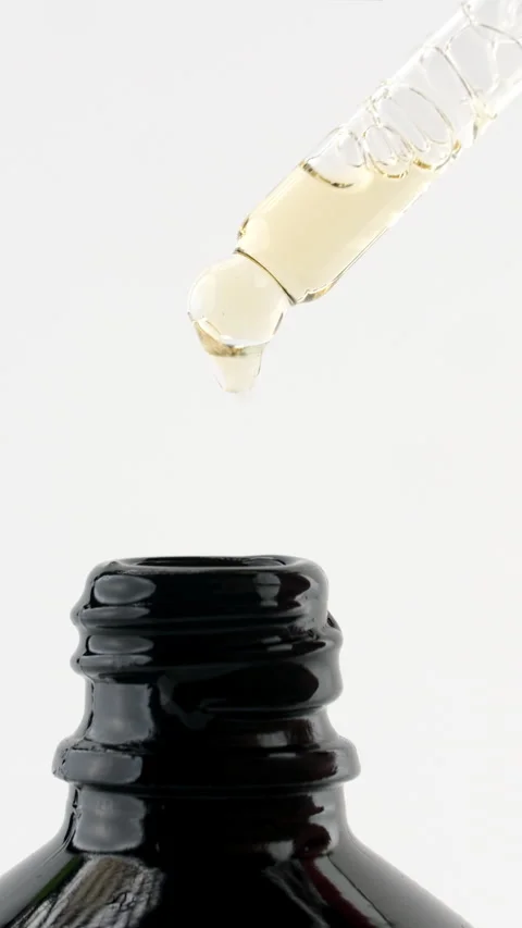 Drop of serum falling into open bottle Stock Footage 311055822