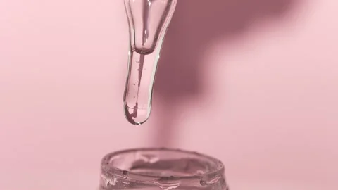 A drop of serum falls from the cap pipette into the container. Transparent gel Stock Footage 201210765