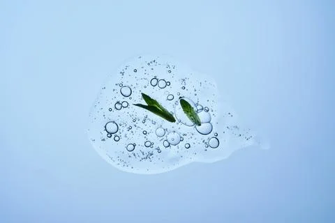 A drop of shampoo with bubbles. A texture with a leaf in it. Stock Photos