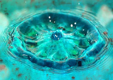 Drop on the surface of a liquid Stock Photos