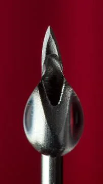 A drop on the tip of the needle of an injection syringe Stock Photos