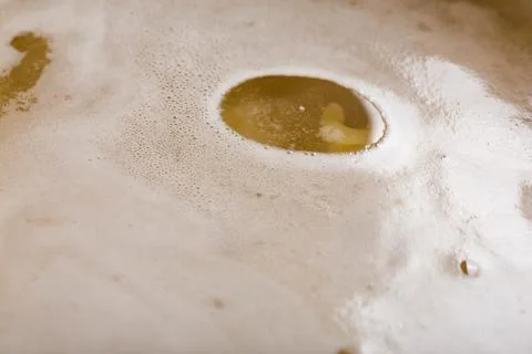 Drop of vegetable oil on the surface of a broth or vegan soup Fotos de archivo