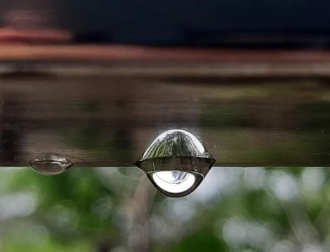 Drop of water and it's reflection. Stock Photos